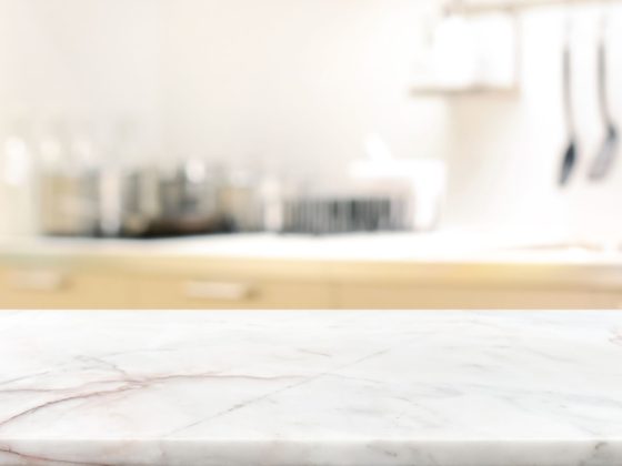 A close up image of a marble countertop with an out of focus background.