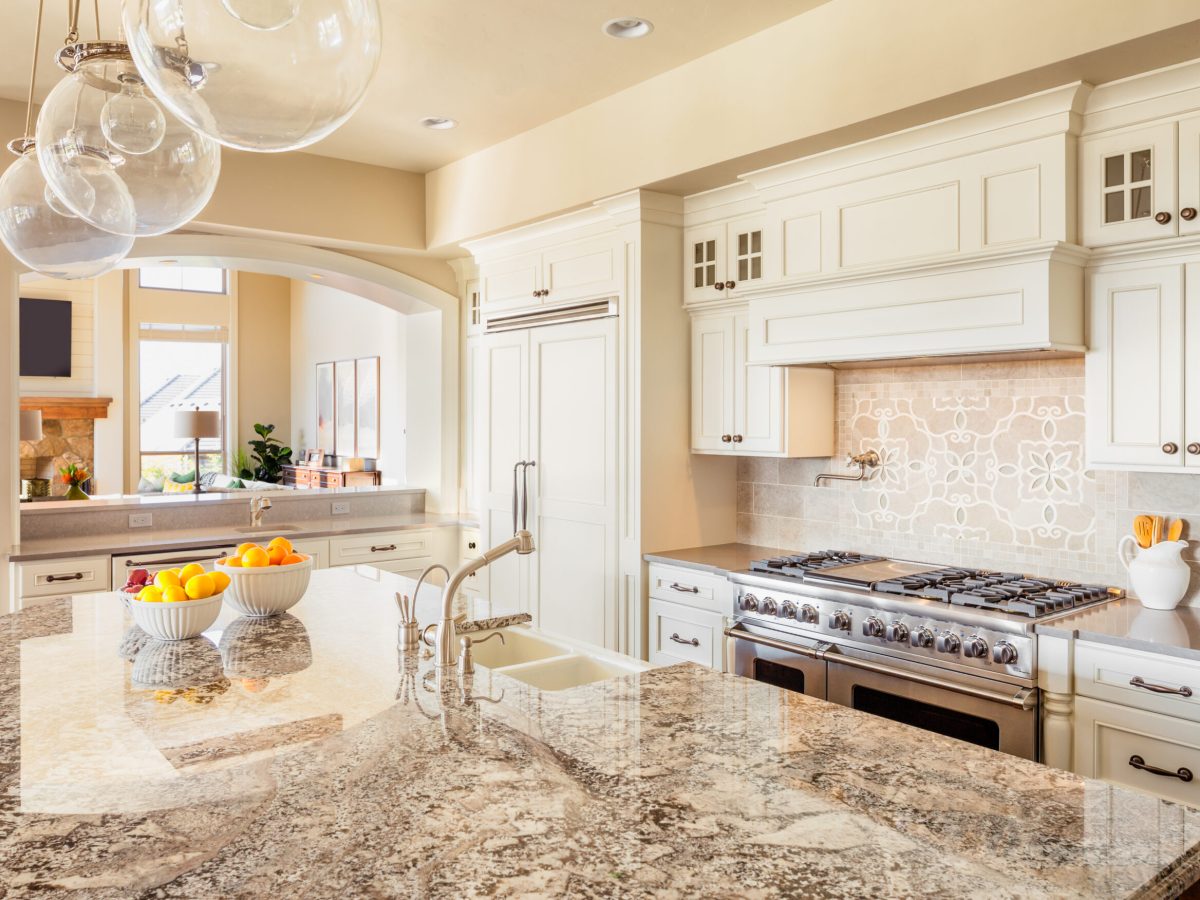 Kitchen with Island, Sink, Cabinets, and Hardwood Floors